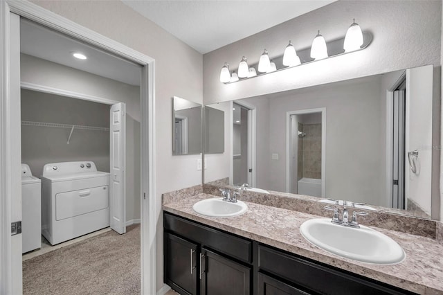 bathroom with separate washer and dryer, vanity, and  shower combination