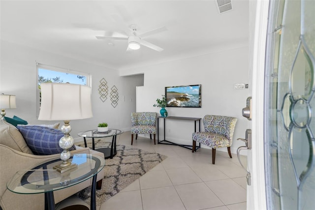 tiled living room featuring ceiling fan