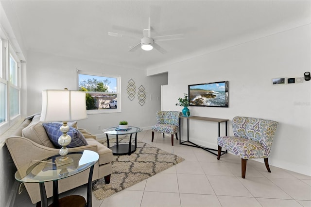 living area featuring ceiling fan, light tile patterned floors, and a wealth of natural light