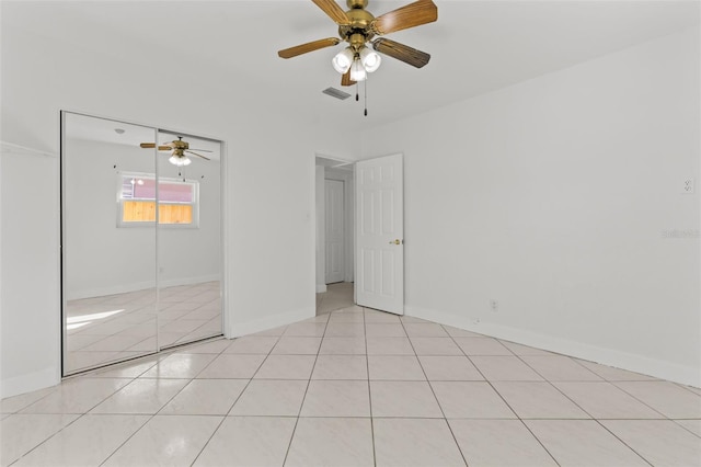 unfurnished bedroom with ceiling fan, a closet, and light tile patterned floors