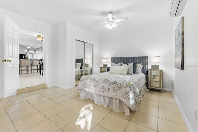 tiled bedroom with a closet, an AC wall unit, and ceiling fan