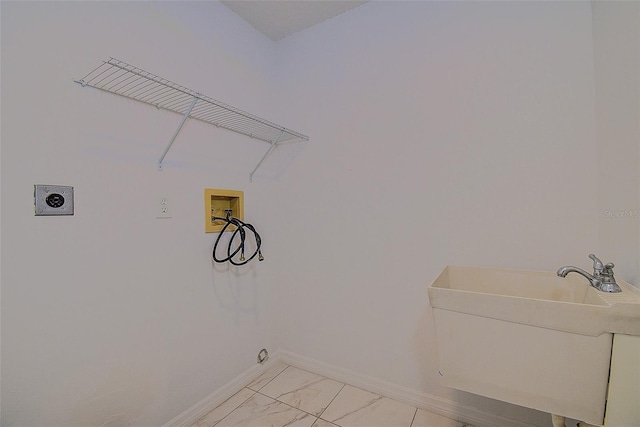 laundry area with hookup for an electric dryer, sink, and hookup for a washing machine