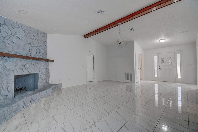 unfurnished living room with vaulted ceiling with beams, a stone fireplace, a chandelier, and a textured ceiling