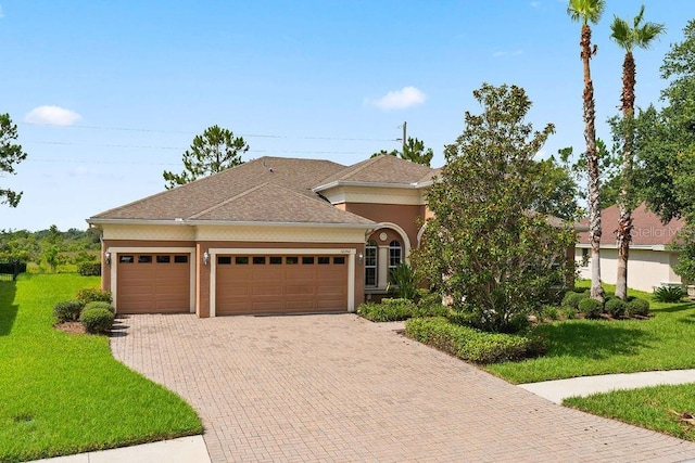 view of front of home with a front yard and a garage