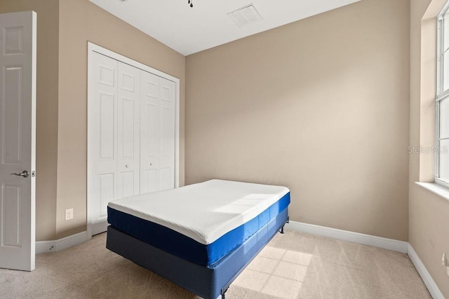 carpeted bedroom featuring a closet