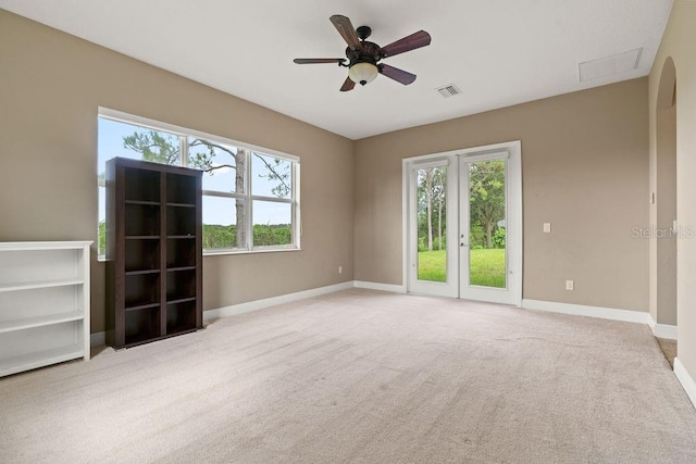 carpeted spare room with ceiling fan