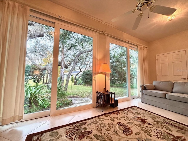 entryway with ceiling fan, light tile patterned floors, and a wealth of natural light