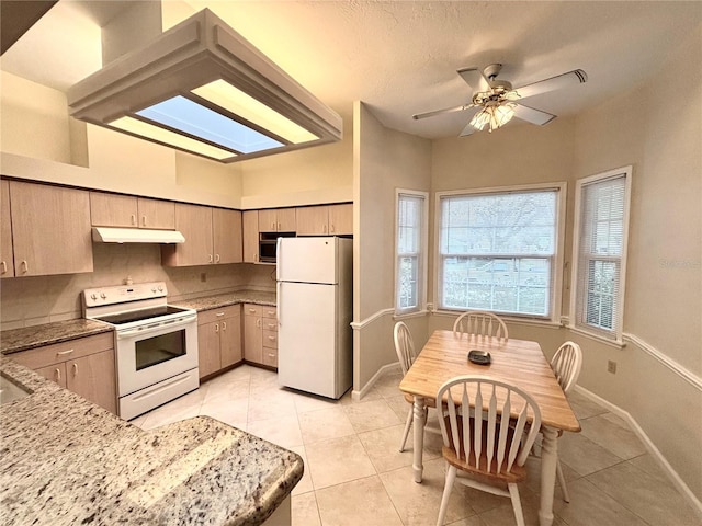 kitchen featuring ceiling fan, white appliances, light tile patterned floors, and light brown cabinetry