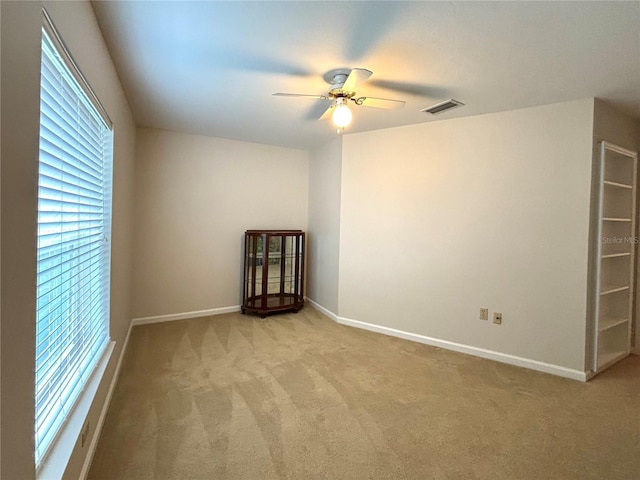 empty room with light carpet and ceiling fan