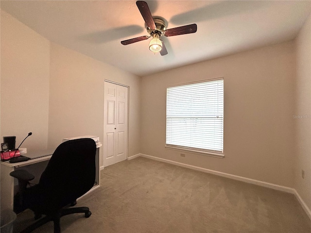 carpeted home office with ceiling fan