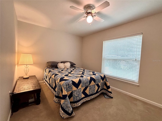 bedroom with ceiling fan, carpet flooring, and multiple windows