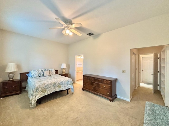 carpeted bedroom featuring ceiling fan and ensuite bath