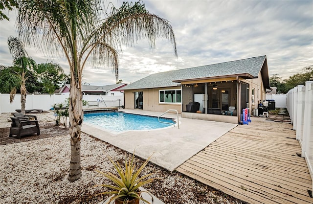 view of swimming pool featuring a patio area and ceiling fan