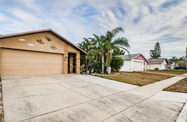 single story home featuring a garage and an outbuilding