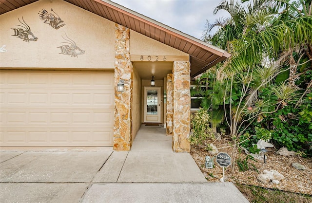 doorway to property with a garage