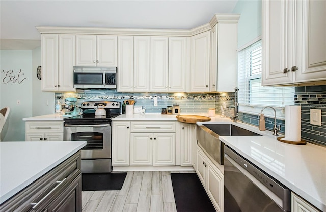 kitchen featuring light wood-type flooring, appliances with stainless steel finishes, and sink