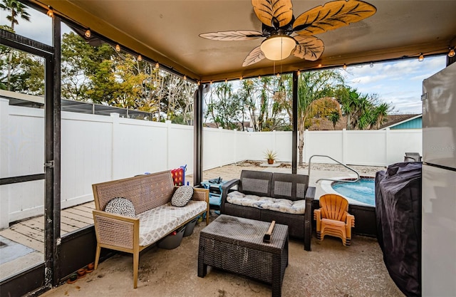 sunroom / solarium featuring ceiling fan