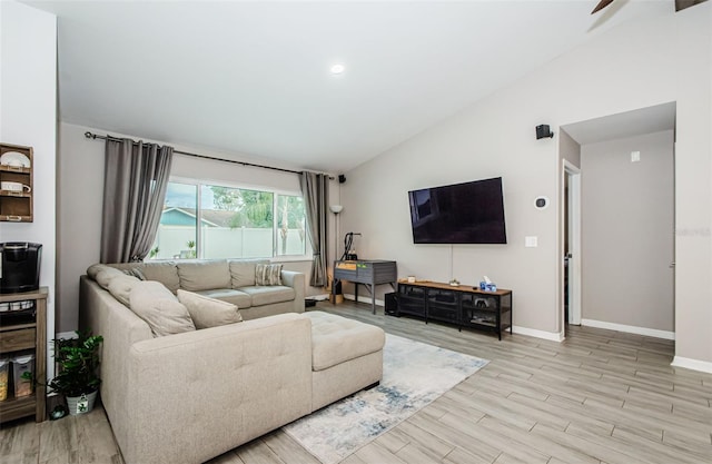 living room with lofted ceiling and light hardwood / wood-style floors