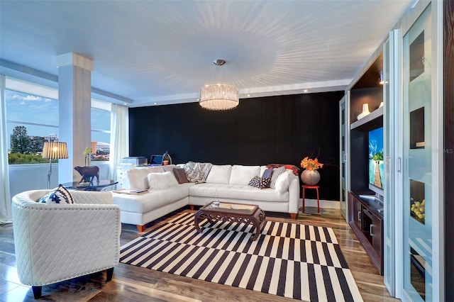 living room with a notable chandelier and dark wood-type flooring