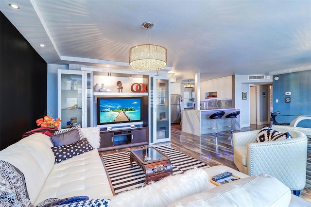 living room with a notable chandelier and hardwood / wood-style flooring