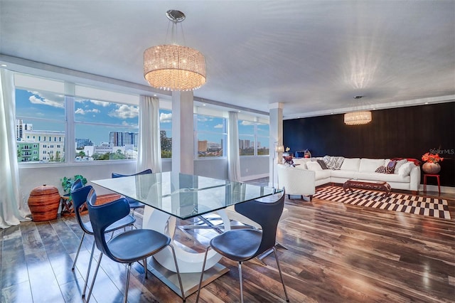 dining area with an inviting chandelier and dark hardwood / wood-style floors