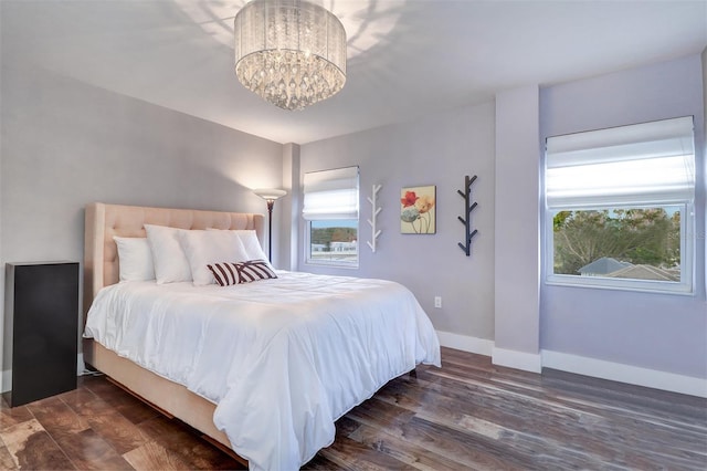 bedroom featuring dark hardwood / wood-style floors and a chandelier