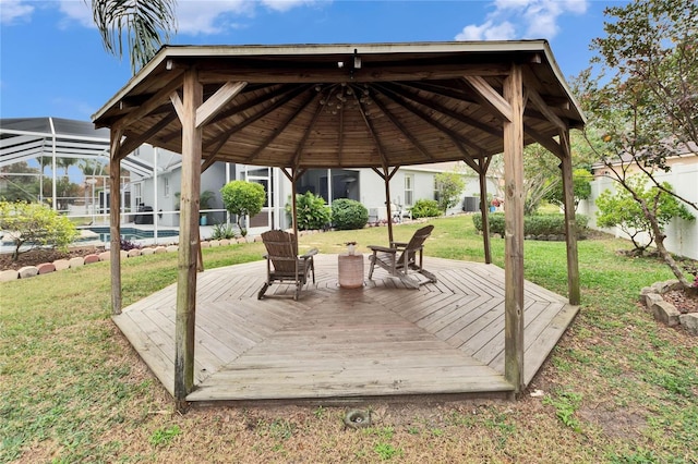 deck featuring a lanai, a gazebo, and a lawn