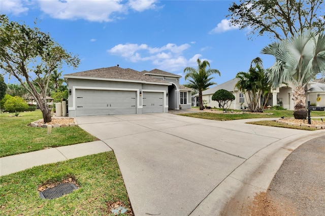 view of front of property with a front yard and a garage