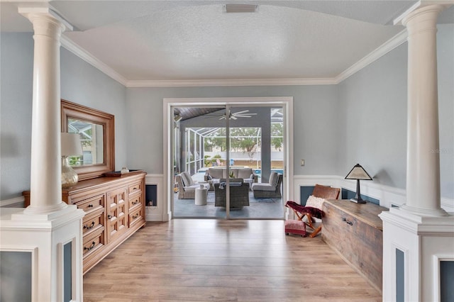 living area featuring a textured ceiling, ornamental molding, and light hardwood / wood-style flooring