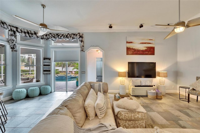 living room with ceiling fan and ornamental molding