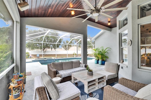 view of patio / terrace with ceiling fan, glass enclosure, outdoor lounge area, and a fenced in pool