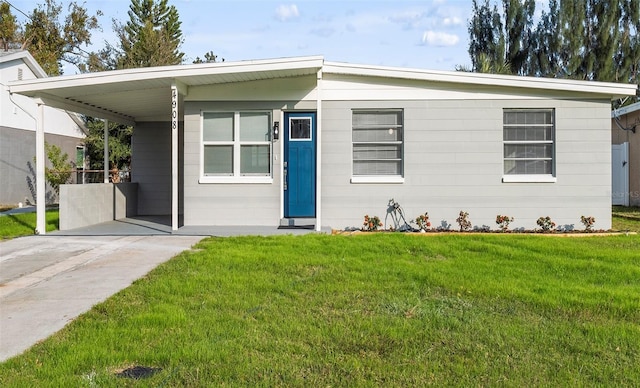 view of front facade with a front yard and a carport