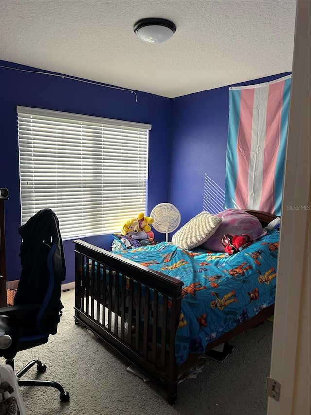 bedroom featuring carpet and a textured ceiling