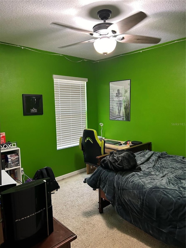 bedroom with carpet, a textured ceiling, and ceiling fan