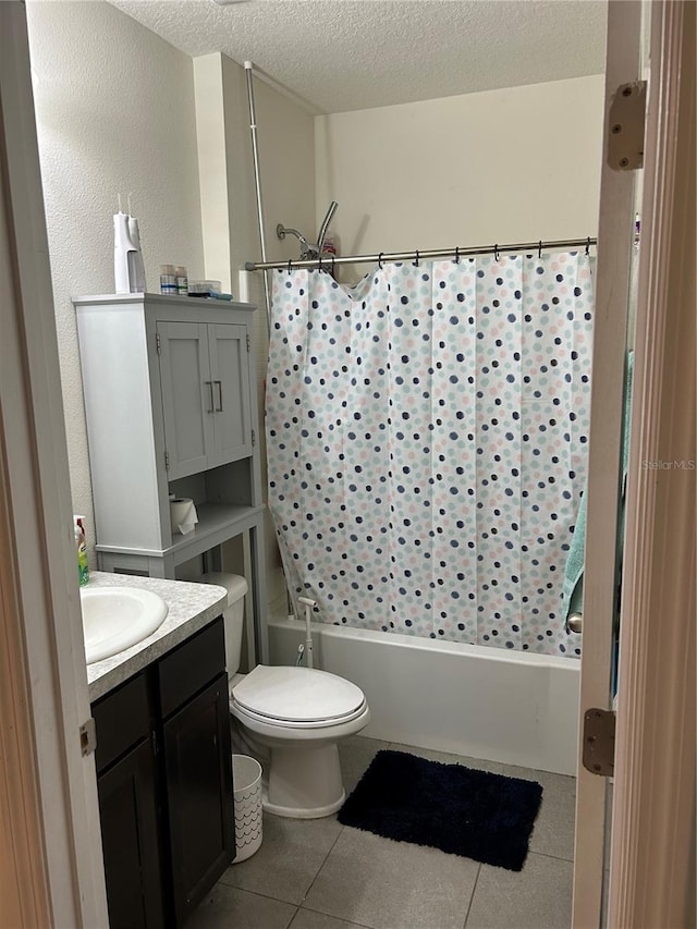 full bathroom with vanity, tile patterned flooring, toilet, a textured ceiling, and shower / tub combo