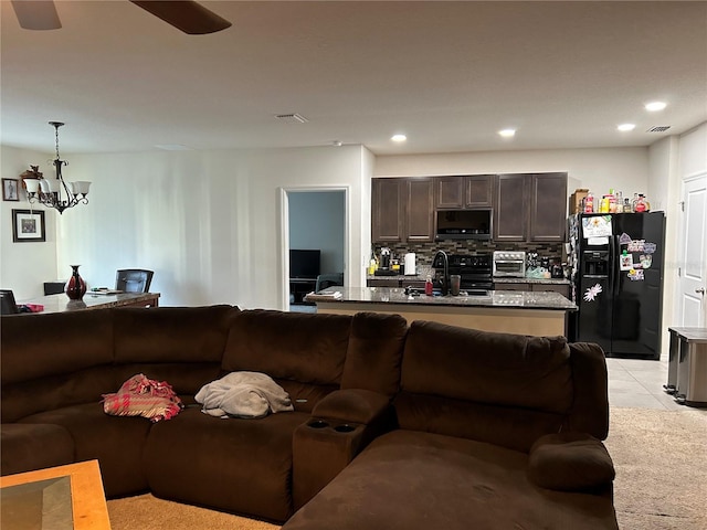 living room with a chandelier and light tile patterned flooring