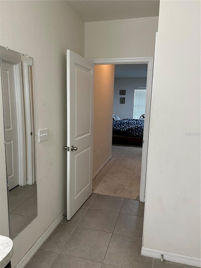 hall with light tile patterned floors