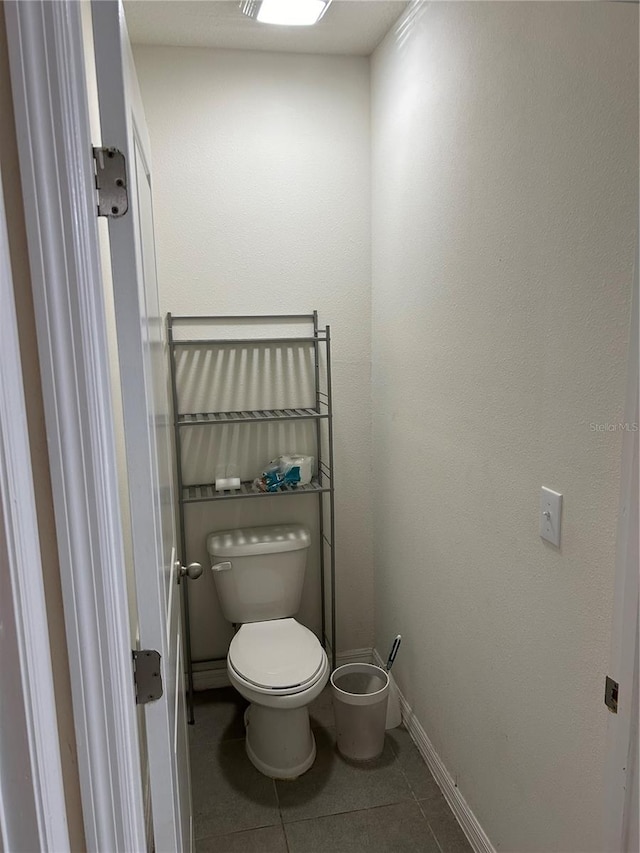 bathroom featuring tile patterned flooring and toilet