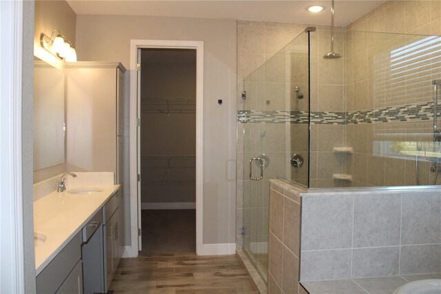 bathroom with an enclosed shower, vanity, and hardwood / wood-style flooring