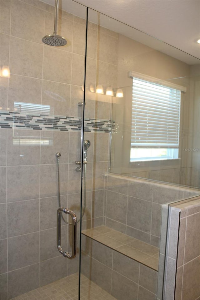 bathroom with a shower with door