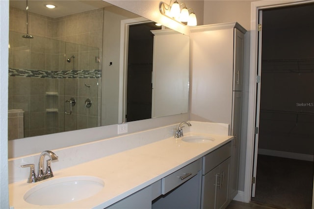 bathroom featuring an enclosed shower and vanity