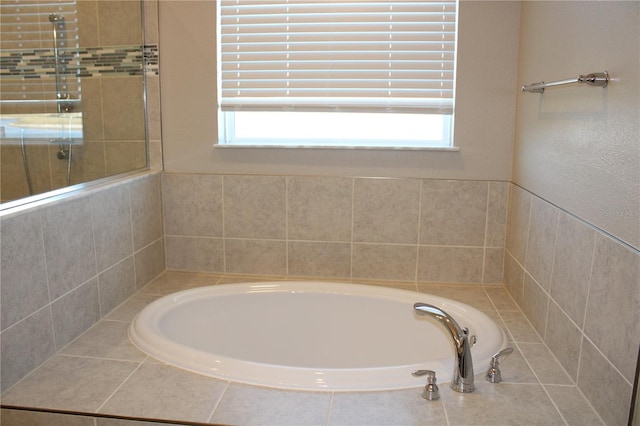 bathroom featuring a healthy amount of sunlight and a tub