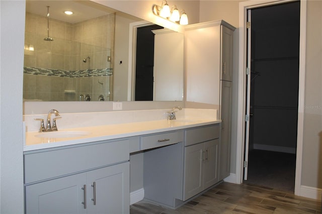 bathroom featuring an enclosed shower and vanity