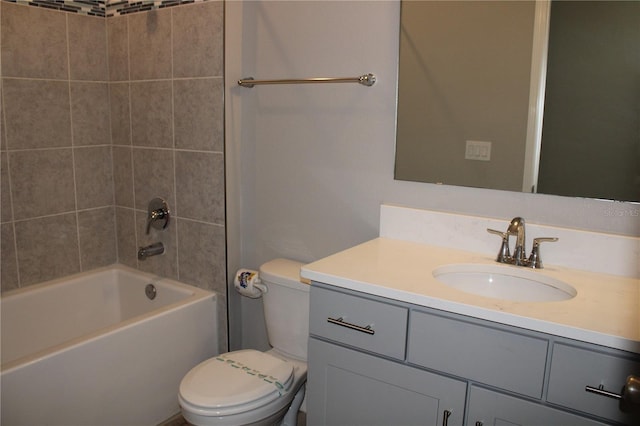 full bathroom with toilet, vanity, and tiled shower / bath