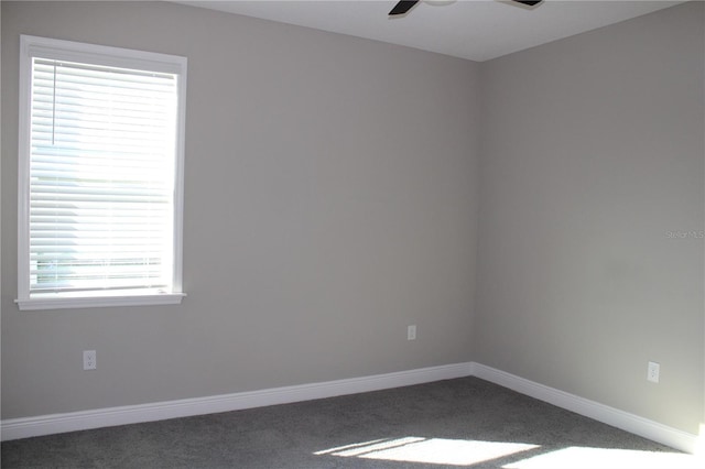 carpeted empty room featuring ceiling fan and plenty of natural light