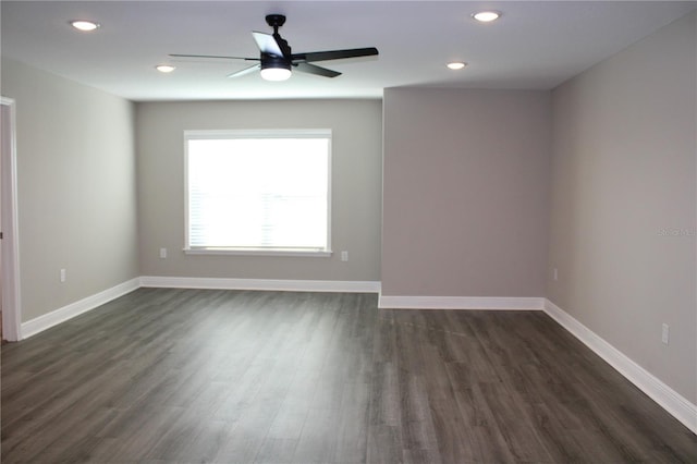 empty room featuring ceiling fan and dark hardwood / wood-style floors