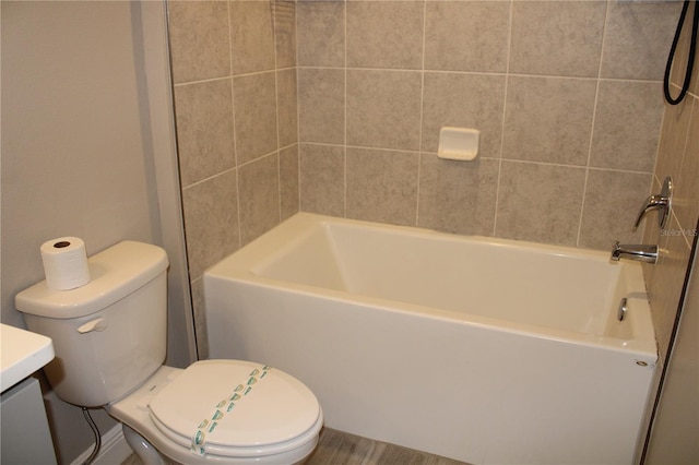 full bathroom with toilet, vanity, and tiled shower / bath combo