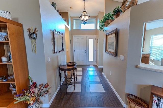 entrance foyer with plenty of natural light and a chandelier