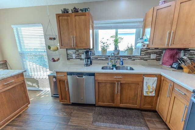 kitchen with sink, backsplash, and stainless steel dishwasher