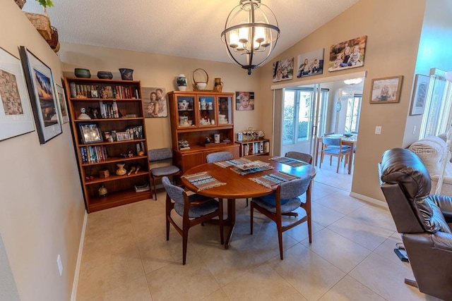 dining space with vaulted ceiling, light tile patterned floors, and an inviting chandelier